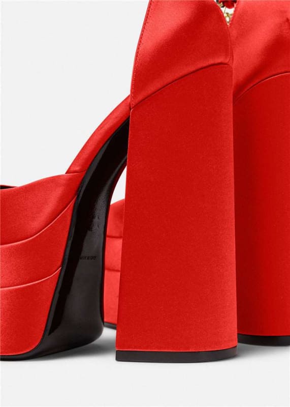 Red high-heeled platform shoes with chunky heels.