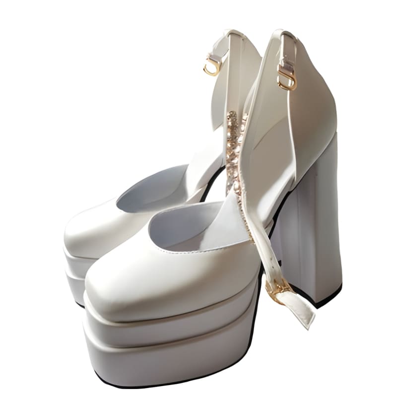 White platform high heels with ankle straps and chunky soles.