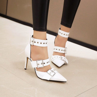 White pointed-toe high heels with multiple straps and buckle details.