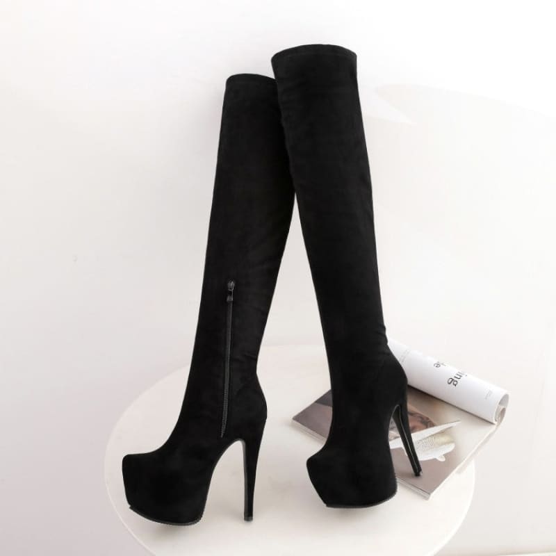 Pair of black high-heeled over-the-knee boots with platform soles.