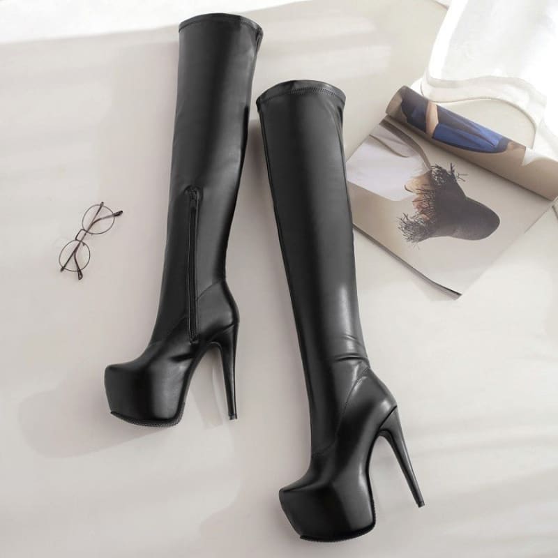 Pair of black leather thigh-high platform boots with extremely high stiletto heels.