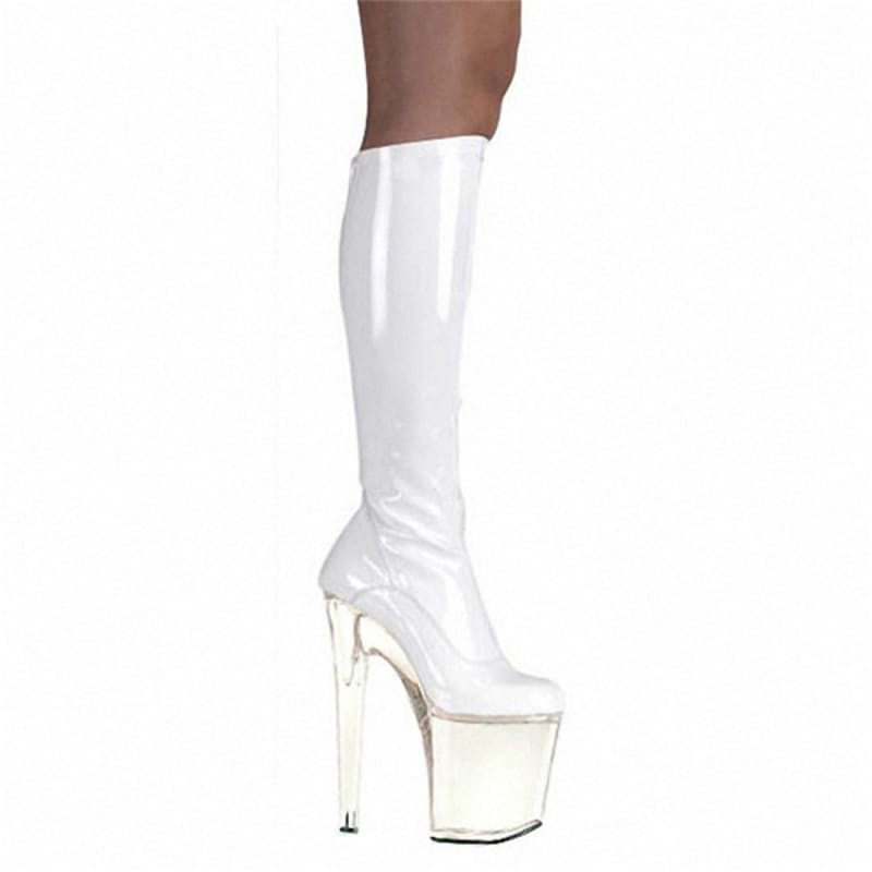 White patent leather knee-high platform boot with an extremely high heel.