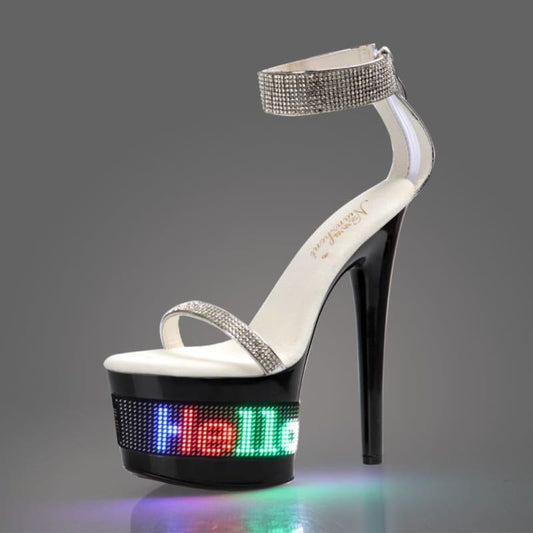 High-heeled platform sandal with a rhinestone ankle strap and LED-lit base displaying colorful text.