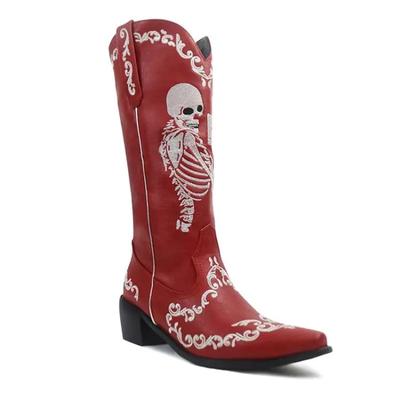 Red cowboy boot with a skeleton design embroidered on it.