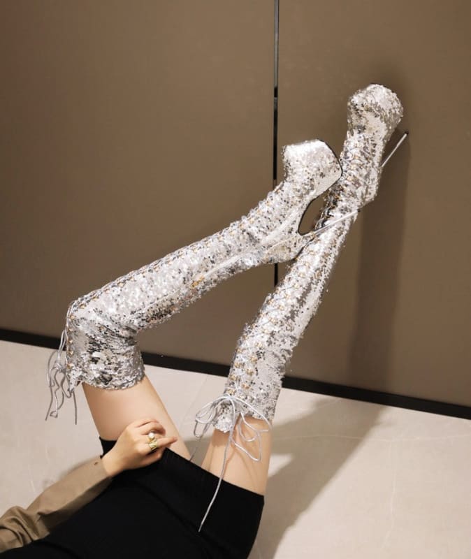 Pair of thigh-high boots covered in glittering silver sequins or crystals.