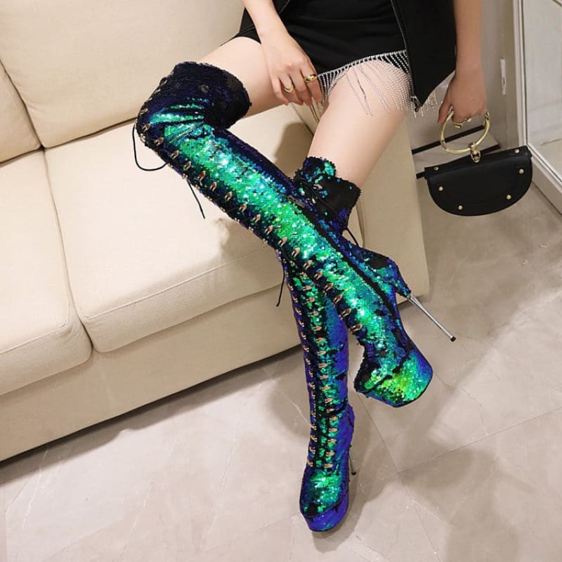 Thigh-high platform boots with iridescent green and blue sequins and lace-up detailing.