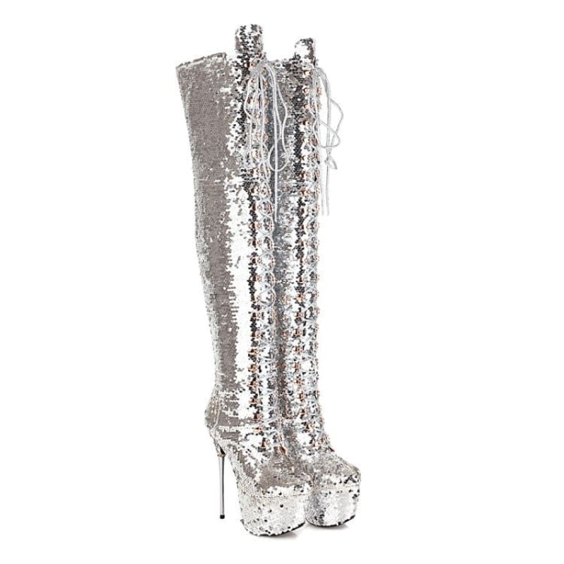 Tall silver sequined platform boot with a stiletto heel.