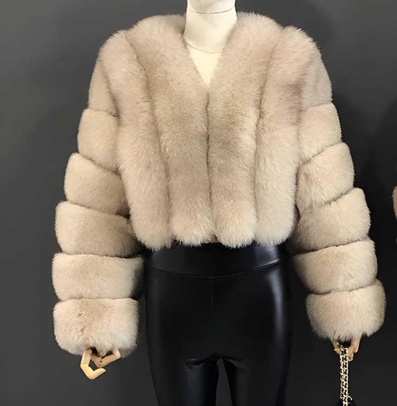 Luxurious beige fur coat with thick, plush segments on the sleeves.