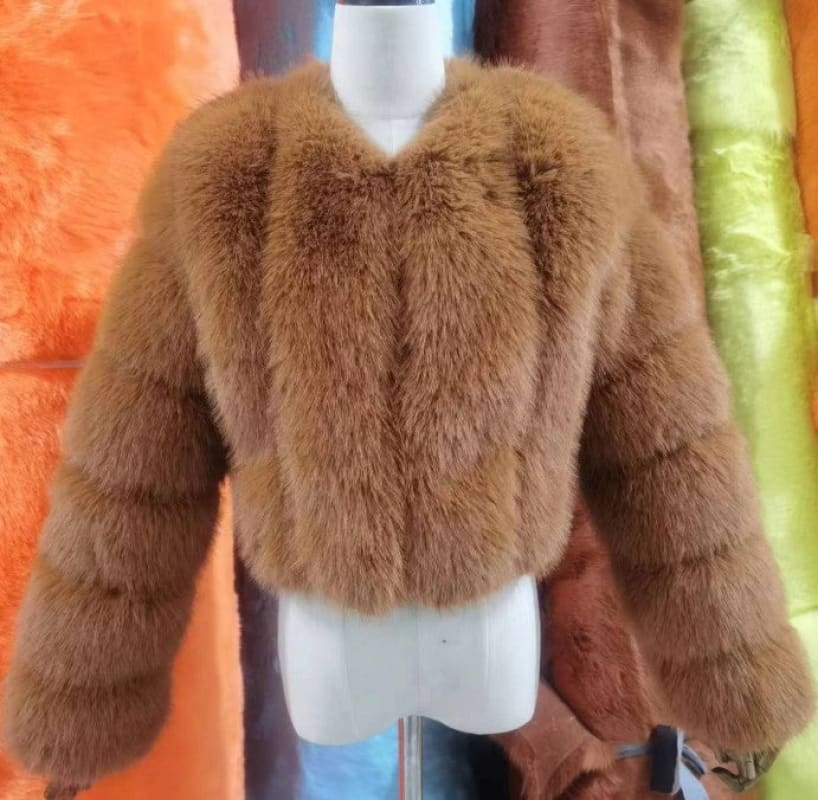 Fluffy brown faux fur jacket with long sleeves.