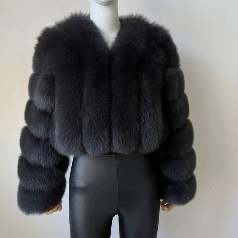 Luxurious black fur coat with a cropped silhouette and puffy sleeves.