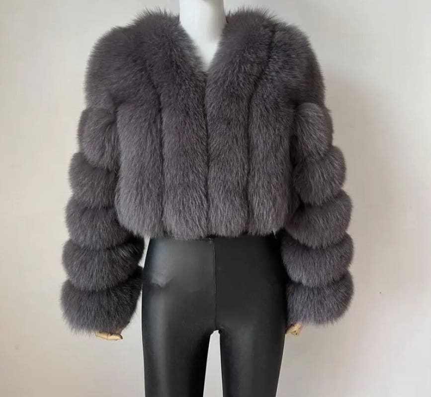 Plush gray fur coat with a cropped length and voluminous sleeves.