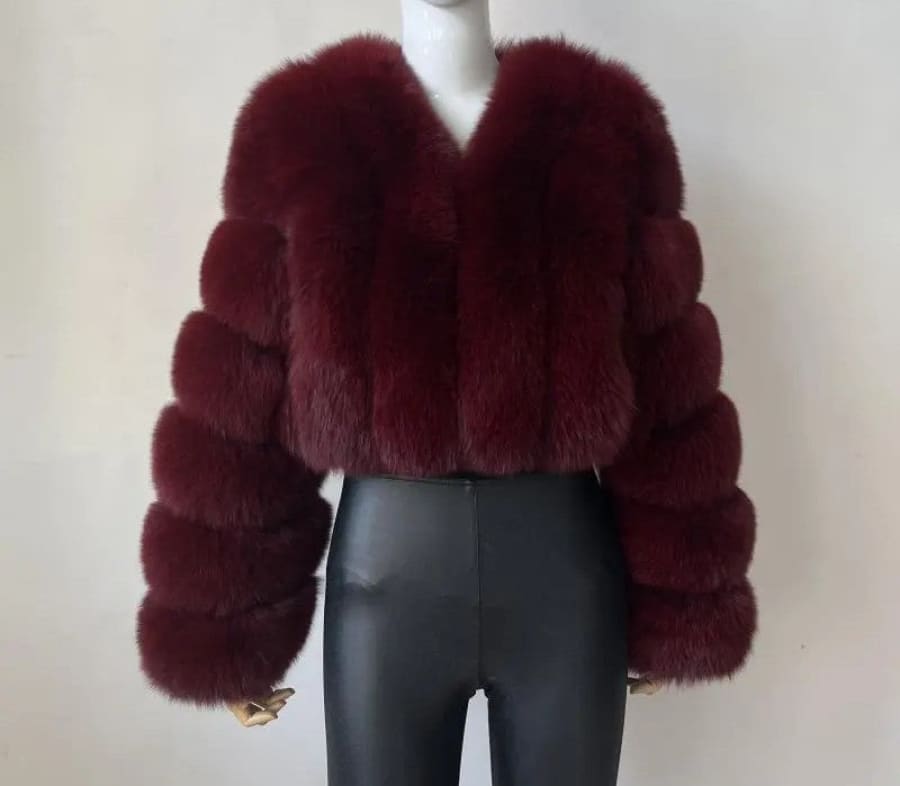 Burgundy faux fur cropped jacket with puffy sleeves.