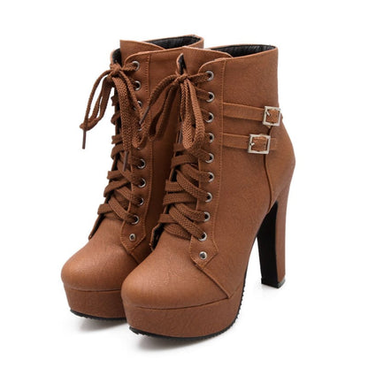 Pair of brown high-heeled ankle boots with laces and buckle straps.