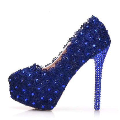 Sparkling blue high-heeled shoe adorned with rhinestones and crystals.