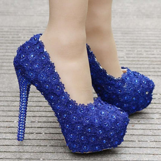 Pair of dazzling royal blue high heels adorned with sequins and crystals.