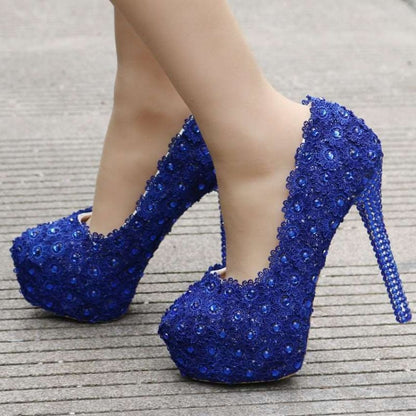 Pair of sparkling royal blue high-heeled platform shoes adorned with sequins or crystals.