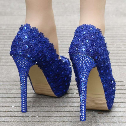 Pair of vibrant blue high-heeled shoes adorned with sparkling crystals or sequins.