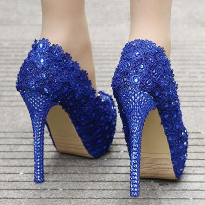 Pair of vibrant blue high-heeled shoes adorned with sparkling crystals or sequins.