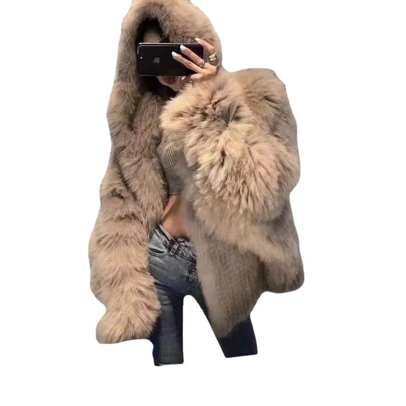 Fluffy beige fur coat worn over jeans and high heels, with hands holding a smartphone.