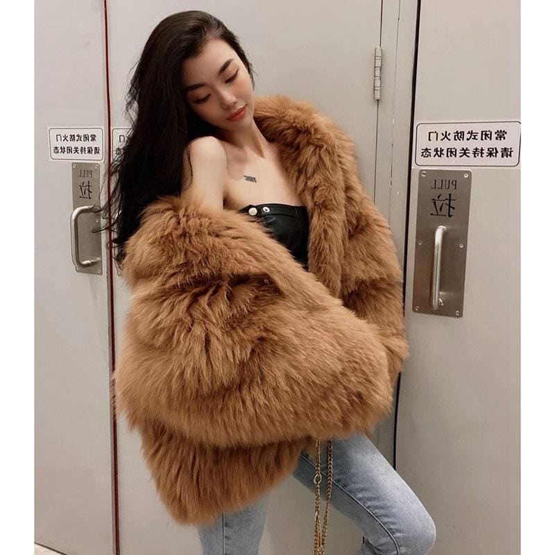 Fluffy, oversized brown fur coat worn by a woman.