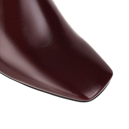 Glossy burgundy leather shoe toe with a square-shaped tip.