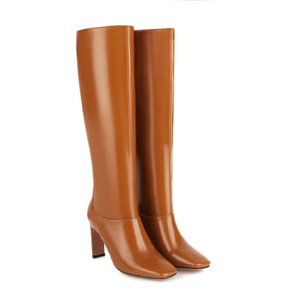 Pair of tall, tan leather boots with high heels.