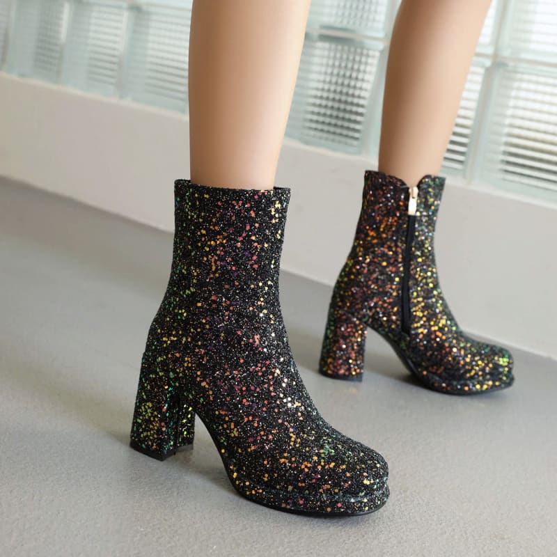 Sparkly black ankle boots with chunky heels and multicolored glitter accents.