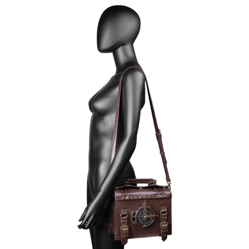 Sleek black mannequin torso with a featureless head, wearing a brown leather messenger bag.