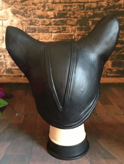 Black leather hood or mask with pointed ears on a display stand.