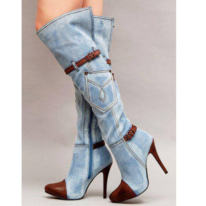 Knee-high denim boots with brown leather accents and high stiletto heels.