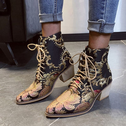 Ornate embroidered ankle boots with lace-up fronts and pointed toes.