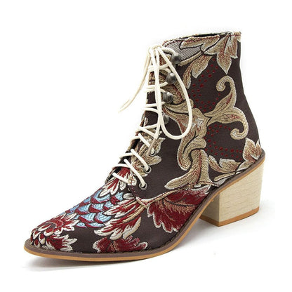 Embroidered ankle boot with floral pattern and lace-up front on a chunky heel.