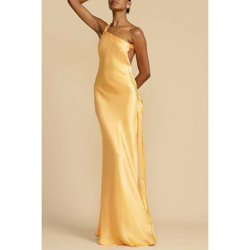 Elegant yellow satin evening gown with one shoulder strap.