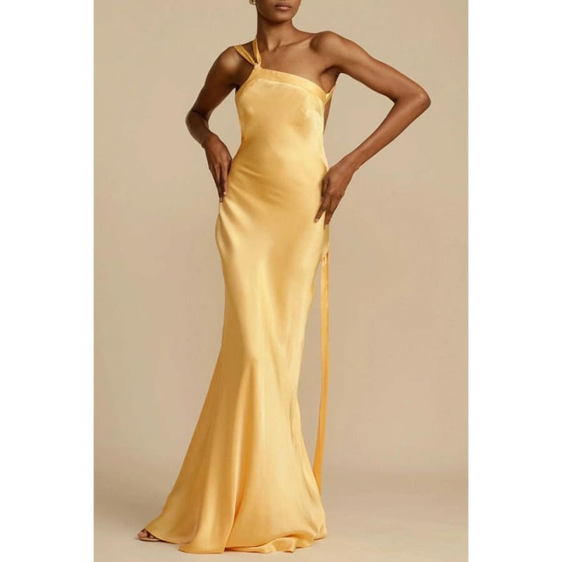 Sleek yellow satin evening gown with spaghetti straps and a form-fitting silhouette.