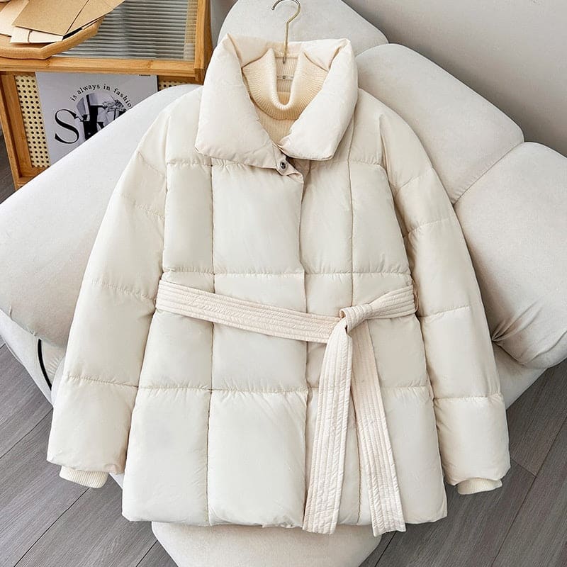 White quilted puffer jacket with a belt.