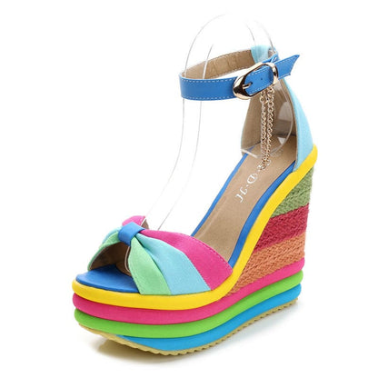 Colorful high-heeled wedge sandal with a rainbow-striped platform sole and multi-hued straps.