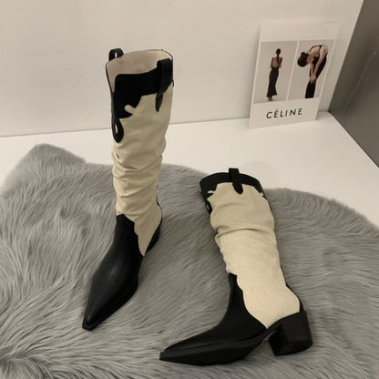 Pair of black and white cowboy-style boots with a slouchy design.