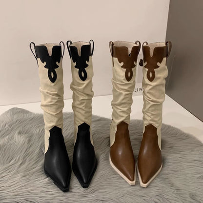 Two pairs of Western-style cowboy boots with contrasting colors and pointed toes.