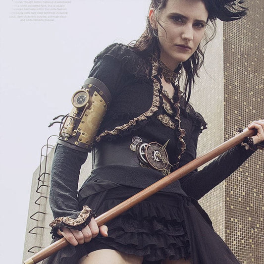 Woman in steampunk-inspired attire holding a wooden staff.