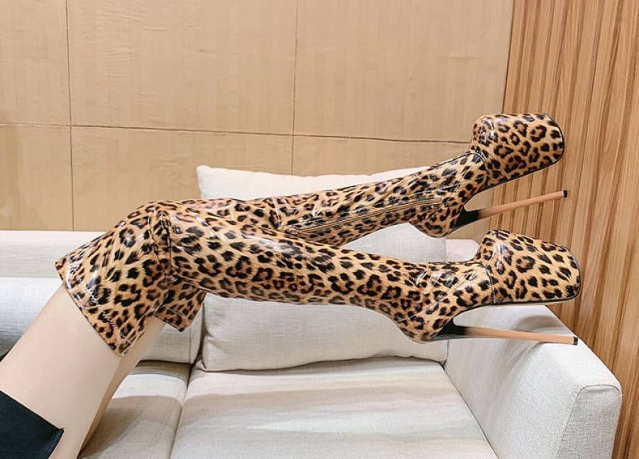 Leopard-print bodysuit or costume stretched across a white couch.