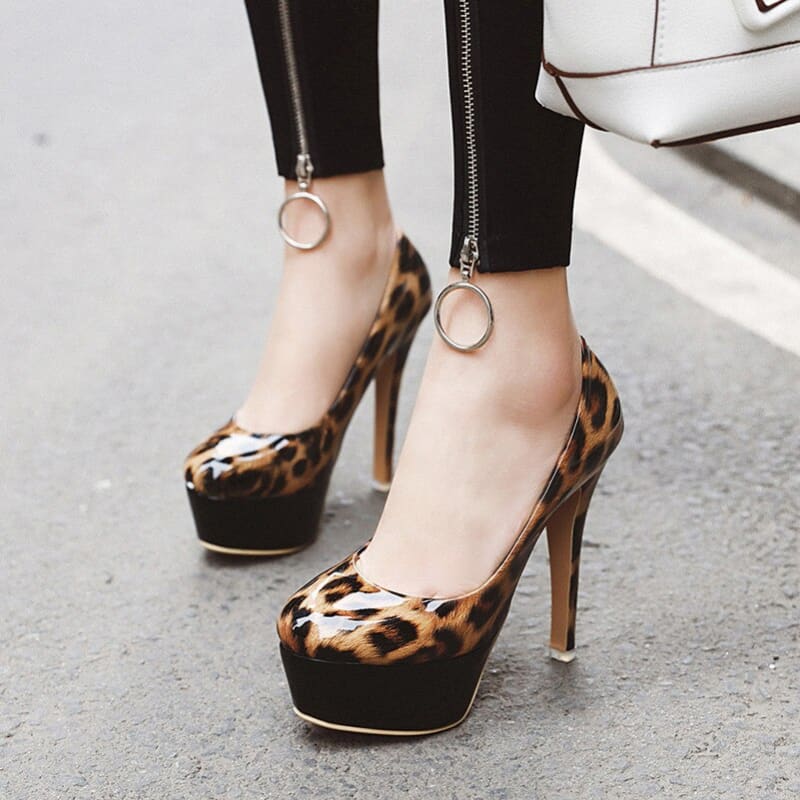 Leopard print high-heeled platform shoes with a peep toe design.