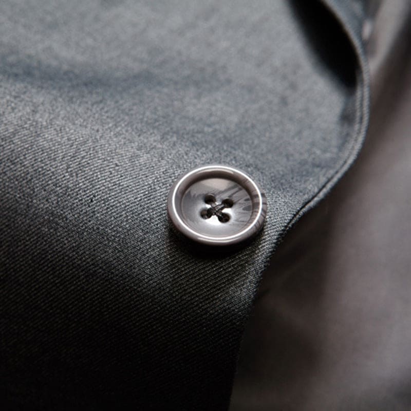 Button on a dark gray fabric garment.