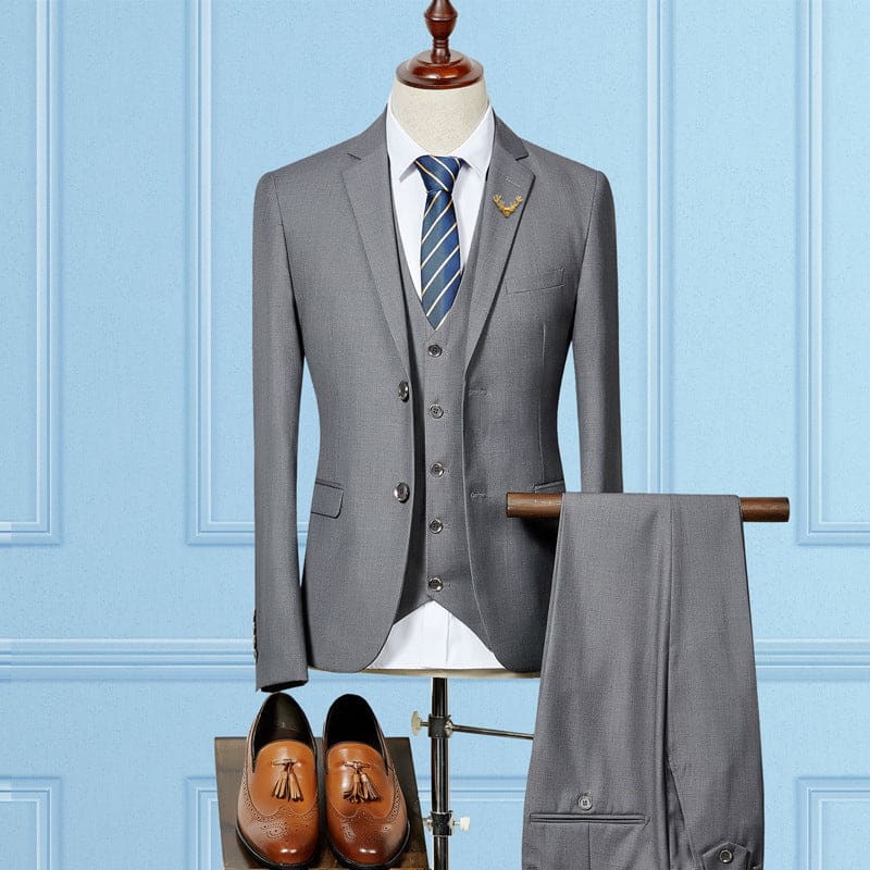 Gray three-piece suit with a blue striped tie displayed on a mannequin torso.