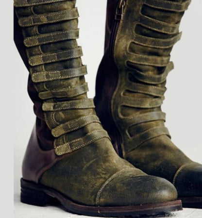 Pair of tall, olive green boots with multiple buckle straps running up the length.