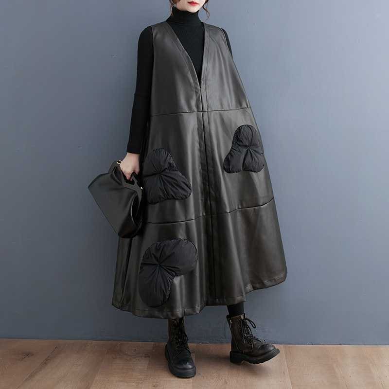 Long, sleeveless leather coat with oversized pockets and floral appliqués.