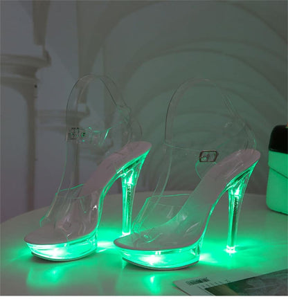 Clear high-heeled platform shoes with glowing green LED lights in the heels and soles.