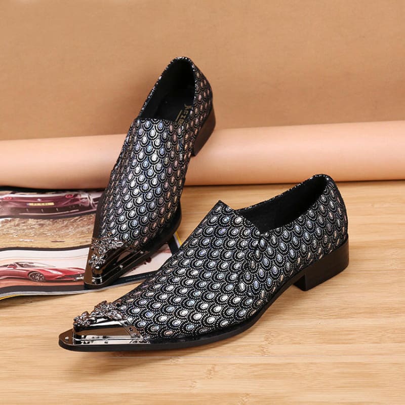 Pair of stylish pointed-toe dress shoes with a metallic patterned design and metal toe caps.