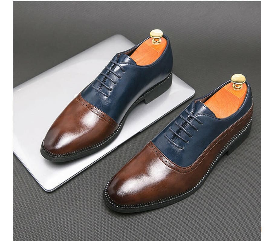 Pair of two-tone leather oxford dress shoes with navy blue and brown coloring.