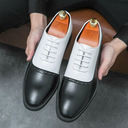 Pair of two-tone leather oxford shoes with black toes and white uppers.