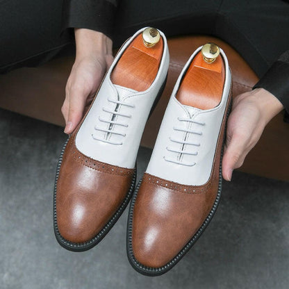 Pair of two-tone leather oxford shoes with brown toes and white uppers.